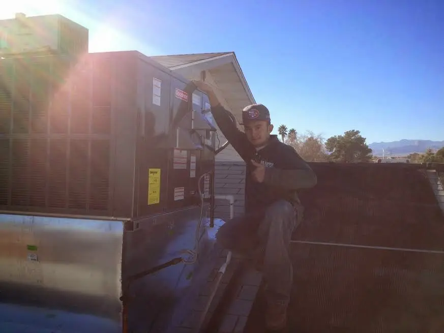 HVAC technician performing AC Tune-Up on a rooftop unit in Clearwater
